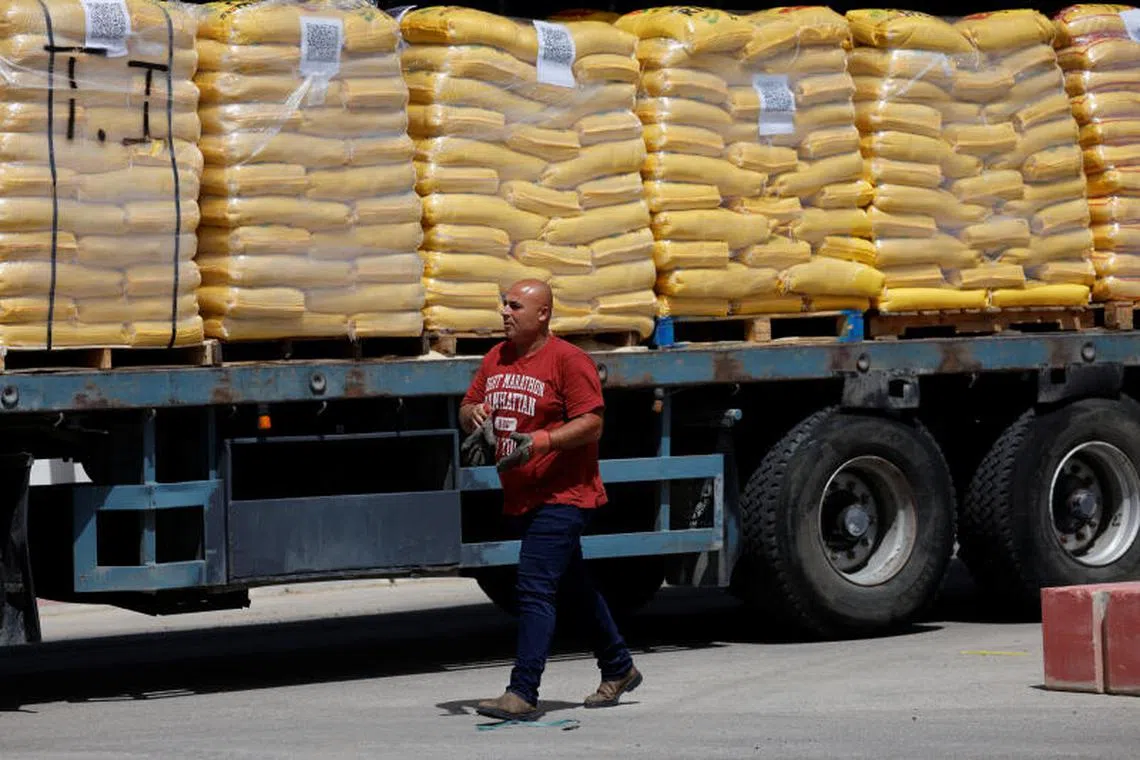 A truck is loaded with aid to be transported into Gaza from Israel, at the Kerem Shalom border crossing between Israel and the Gaza Strip, May 26, 2025. REUTERS/Amir Cohen