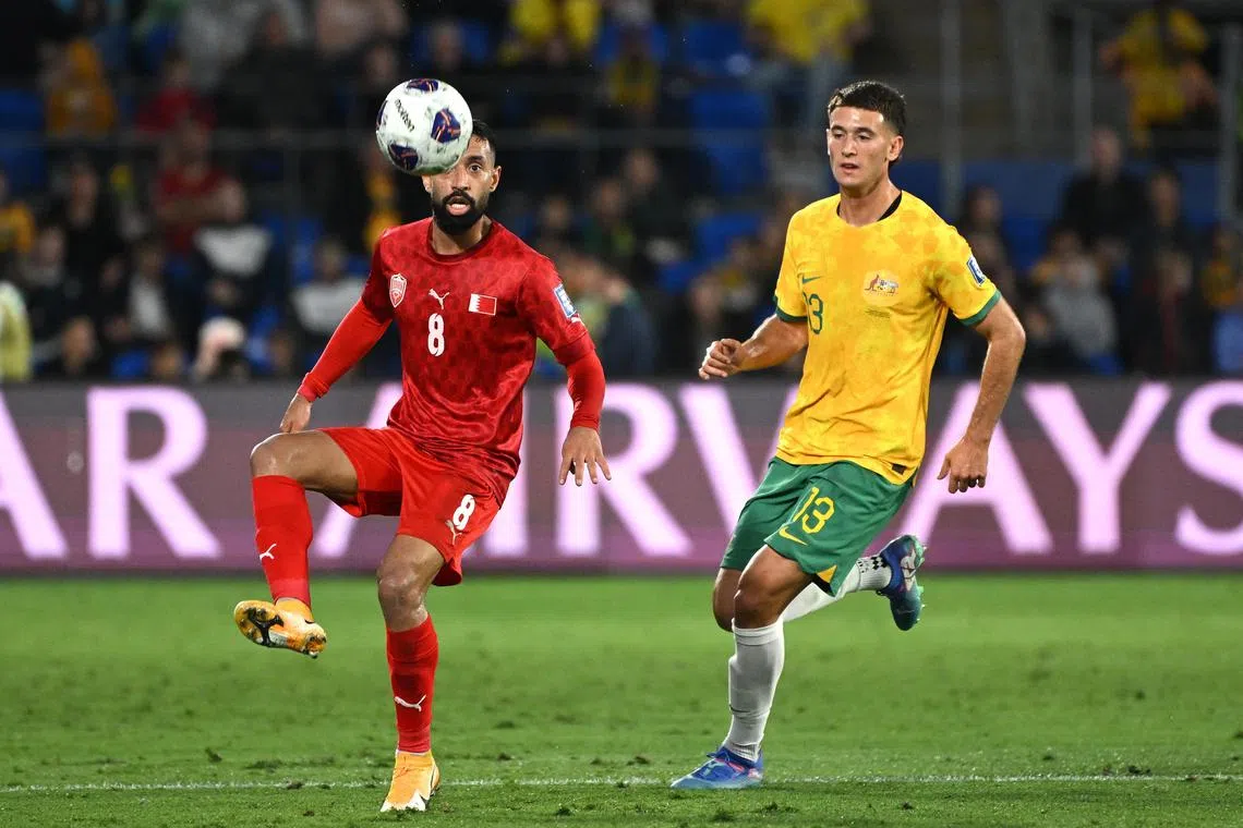 Alessandro Circati of Australia closing down  Mohamed Marhoon of Bahrain in their World Cup third round Asian qualifier at Cbus Super Stadium on the Gold Coast on Sept 5, 2024.
