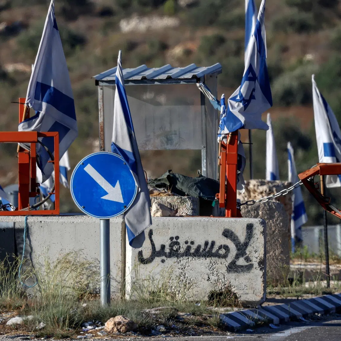 Graffiti reading “no future” in Arabic is depicted on a concrete block at the closed vehicle barrier of a checkpoint at the northern entrance of Ramallah in the Israeli-occupied West Bank.