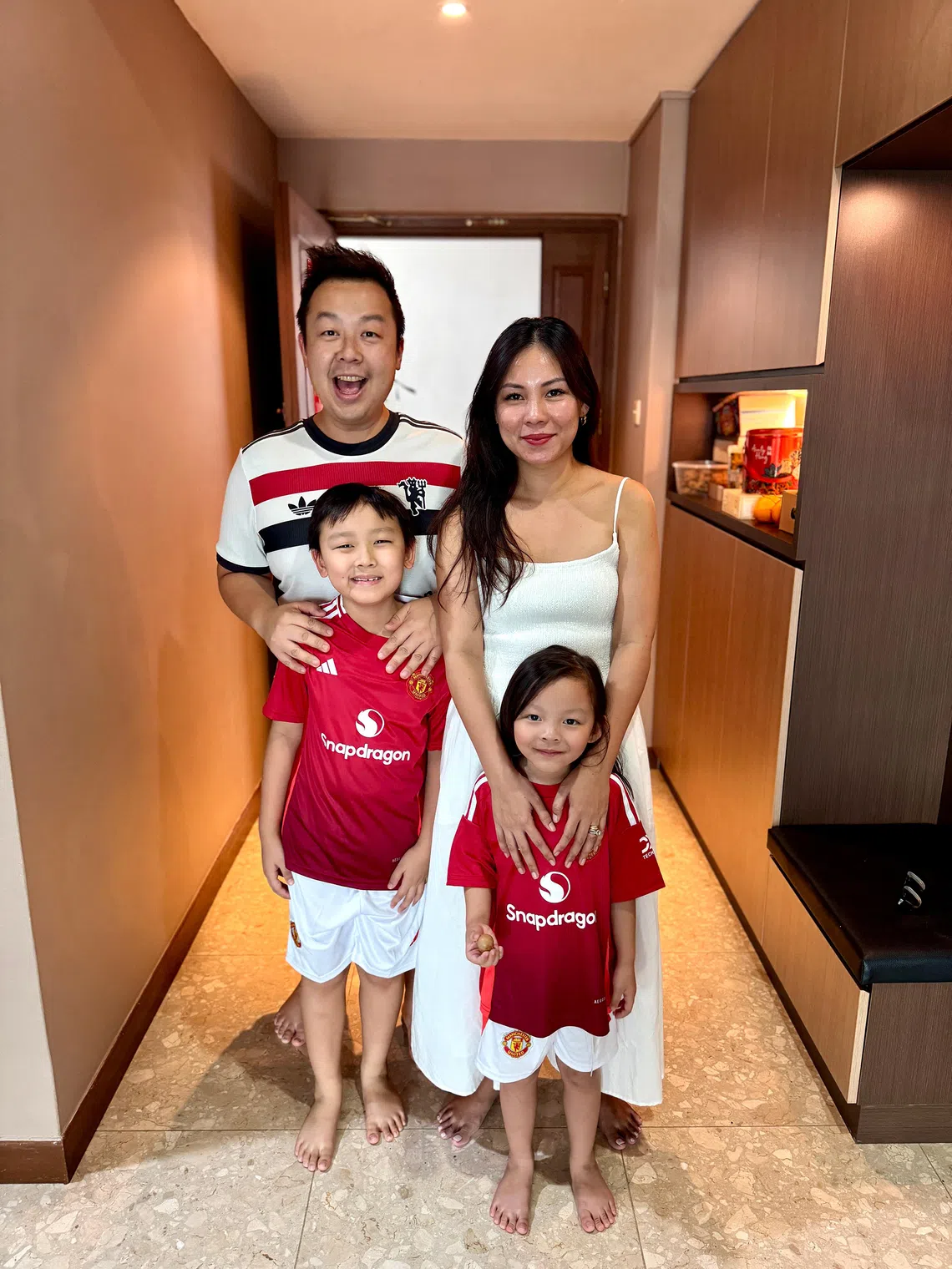 Justin Ko with his wife and children. Under the new measures, Ko and his wife will each get 10 days of leave.