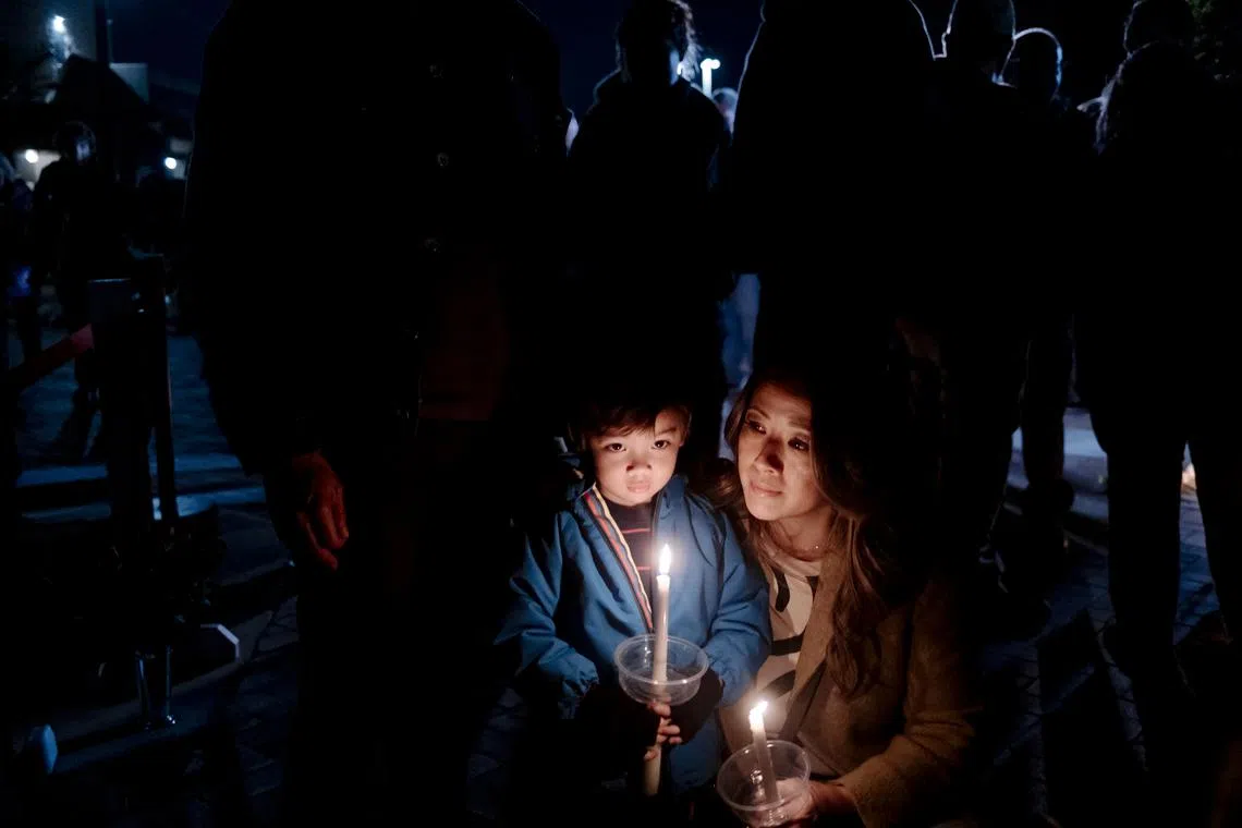 Marina Revuelta with her son at a vigil outside the Star Ballroom Dance Studio in Monterey Park, California, U.S. on Jan. 23, 2023, where 11 people were killed and at least nine others wounded in a shooting rampage on Saturday night. 