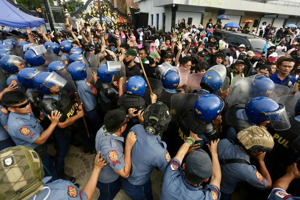 Anti-riot police block supporters of religious leader Apollo Quiboloy as they stage a protest rally outside the Kingdom of Jesus Christ (KJC) compound in Davao city.