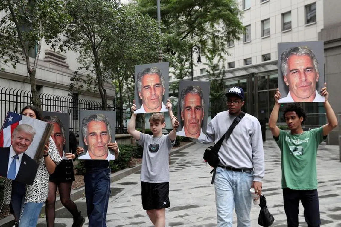 Demonstrators hold signs aloft protesting Jeffrey Epstein in New York on July 8, 2019.