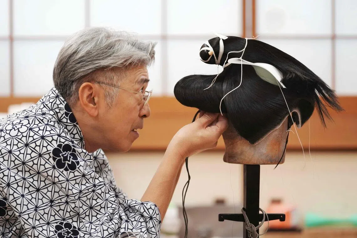 Wig master Tadashi Kamoji creating a wig for kabuki actors at his atelier in Tokyo, on March 11.