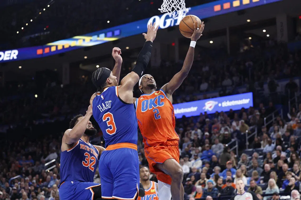 Oklahoma City Thunder guard Shai Gilgeous-Alexander goes to the basket beside New York Knicks guard Josh Hart during the second half at Paycom Center. 