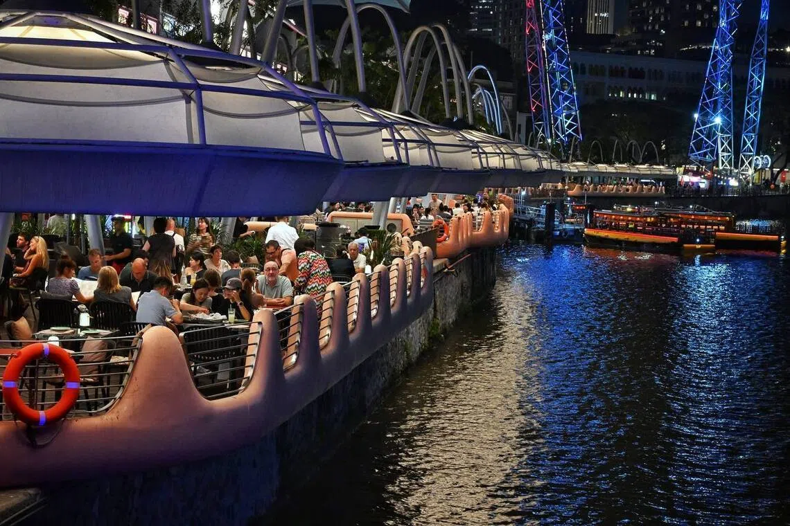 Guests dining at restaurants and bars at Clarke Quay by the Singapore River on Aug 17.