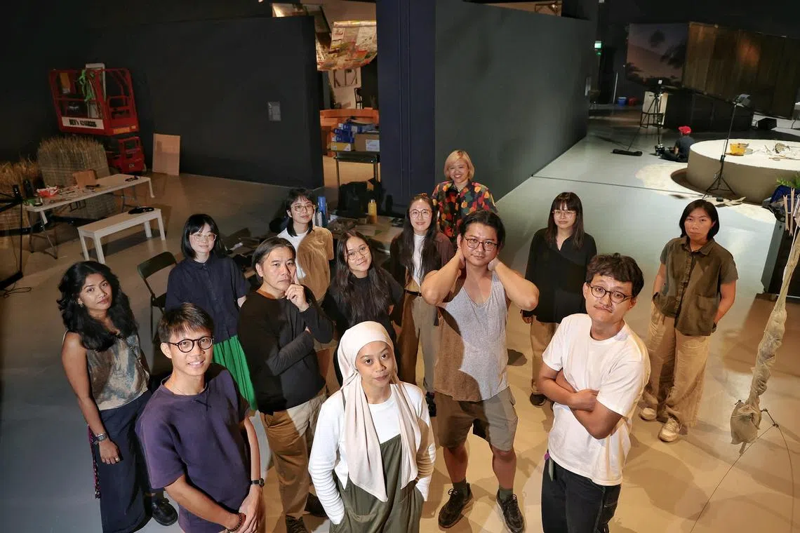 (Front row from left) Artist Chu Hao Pei, artist Lee Pheng Guan, artist NEO_ARTEFACTS, artist Masuri Mazlan, artist Syahrul Anuar, (back row from left) curatorial assistant Angela Pinto, curator Joella Kiu, curatorial assistant for design Siobhan Tang, assistant curator Syaheedah Iskandar, curatorial assistant Seline Teo, curator for design Berny Tan, curatorial assistant Angelica Ong, and curator and manager (Collections) Teng Yen Hui in the space for How to Dream Worlds at Singapore Art Museum on July 18, 2025.