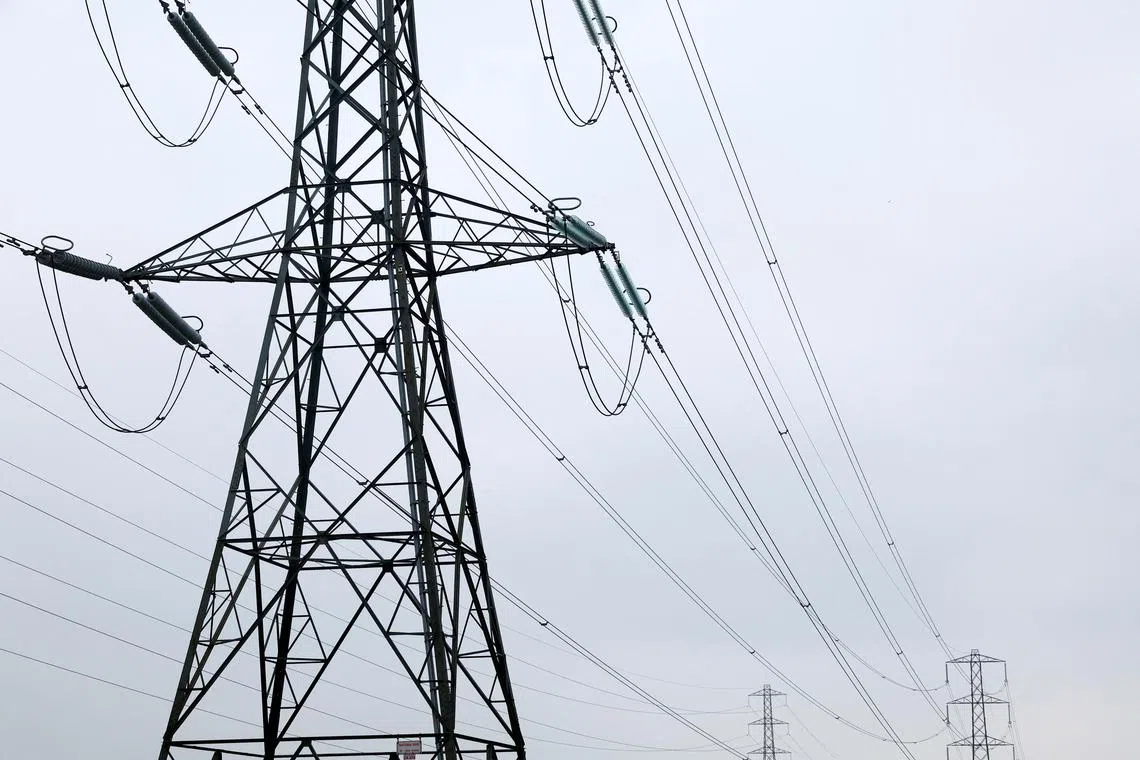 FILE PHOTO: Electricity pylons are seen in Wellingborough, Britain, March 30, 2022. REUTERS/Andrew Boyers/File Photo