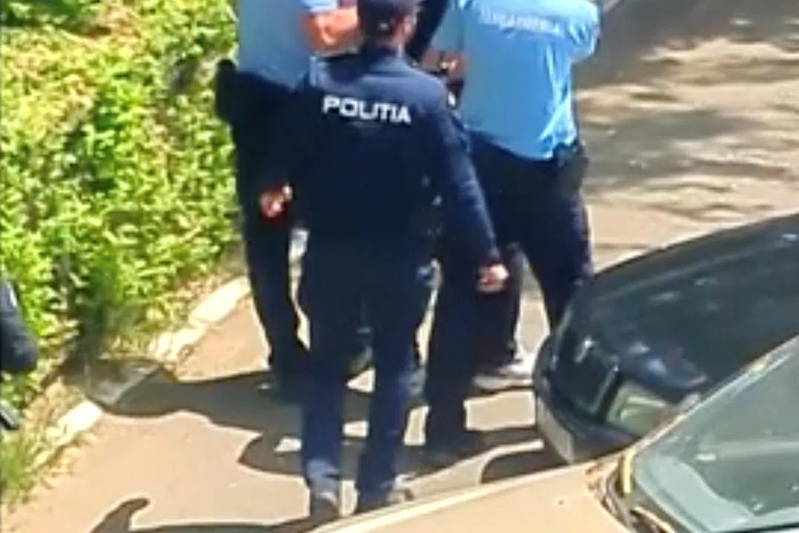 Romanian police escort a suspect outside the police station in Bucharest after a petrol bomb was thrown at the Israeli embassy, in Romania June 3, 2024 in this still image obtained from social media video. Simon Daniel Merticariu via REUTERS