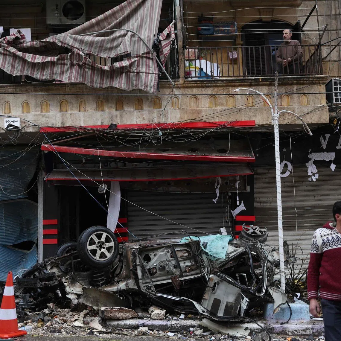 A man crosses the street after a ceasefire in the Kurdish-majority Ashrafiyeh neighbourhood, in the northern city of Aleppo, on Jan 11.