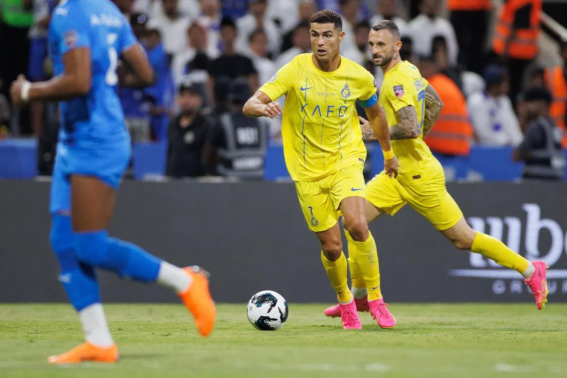Nassr's Portuguese forward #07 Cristiano Ronaldo runs with the ball during the 2023 Arab Club Champions Cup final football match between Saudi Arabia's Al-Hilal and Al-Nassr at the King Fahd Stadium in Taif on August 12, 2023. (Photo by AFP)