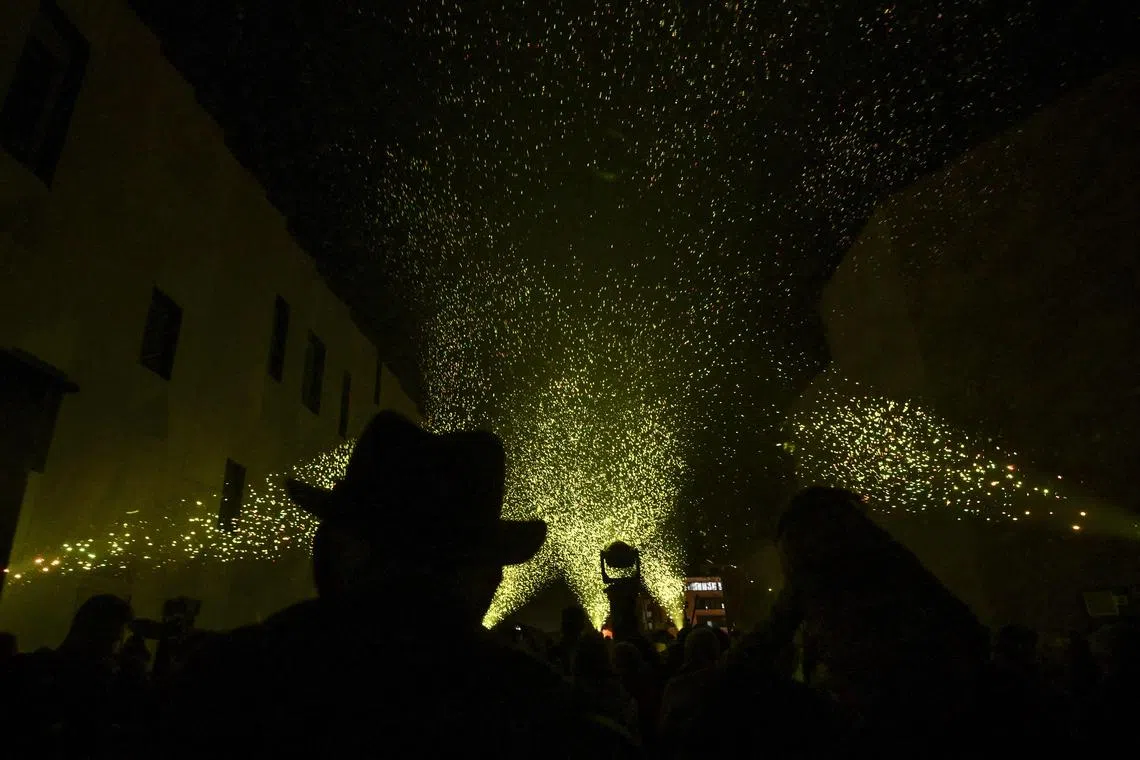 Attendees watch lighted biodegradable bubbles in the air, in Aix-en-Provence on December 21, 2022. 
Sparks but without explosion for a sustainable entertainment, the city of Aix-en-Provence welcomed on December 21, 2022, at the closing of its first Biennial event of art and culture, a firework of a new kind, resolutely ecological. 