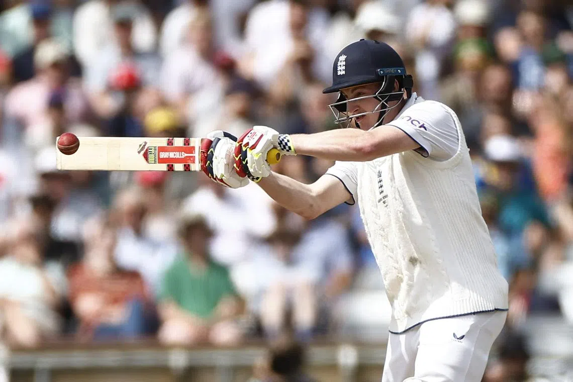 England's Harry Brook plays a shot off the bowling of Australia's Mitchell Starc and is caught out by Pat Cummins.