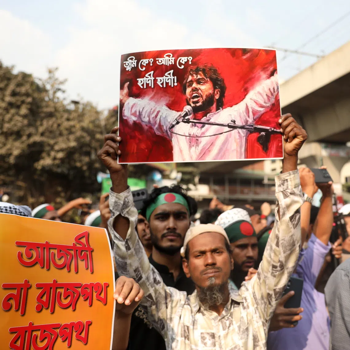 A protester with a photo depicting Mr Sharif Osman Hadi during a demonstration in Dhaka on Dec 19.