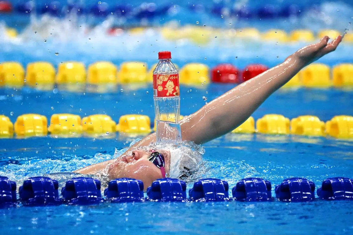 Back to basics as a South Korean swimmer balances a bottle on her head during a training session at the Hangzhou Olympic Sports Centre Aquatic Sports Arena on Sept 25.
