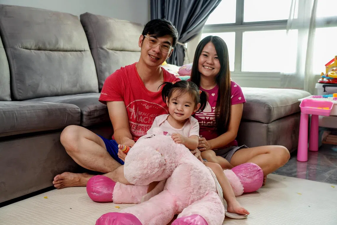 smkid09 - Ms Cheryl Sim with her husband and daughter at their home. 

credit: KidStart