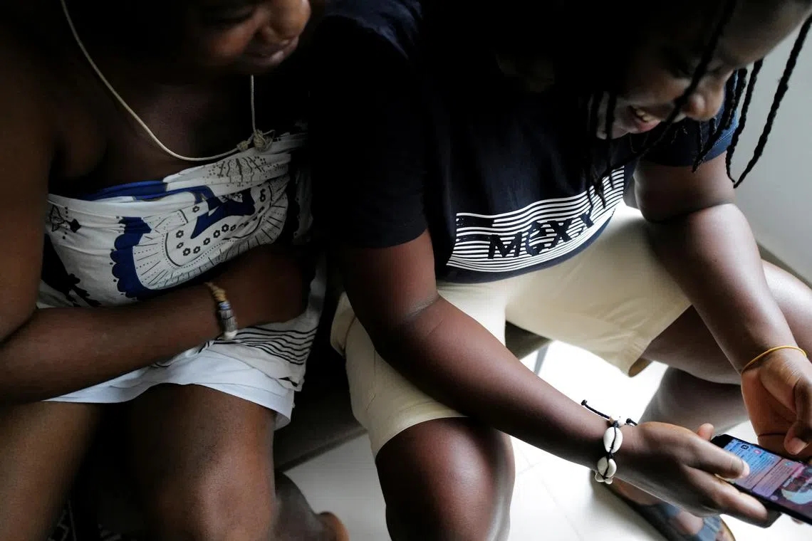 FILE PHOTO: Same-sex couple, Naa Shika, 37, a fetish priestess, and her partner Kay, 27, a human rights activist, sit together during a discussion on the topic of Fiducia Supplicans, a Declaration approved by Pope Francis, that allows Catholic priests to bless same-sex couples, in Accra, Ghana. January 23, 2024. REUTERS/Francis Kokoroko/File Photo
