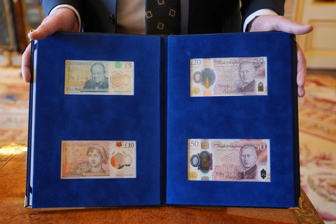 New banknotes bearing a portrait of King Charles, Winston Churchill, and Jane Austen are presented to the King at Buckingham Palace in London on April 9.