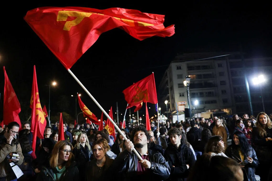 Members of the Communist Party Youth wave flags during a protest on March 4, 2023.  