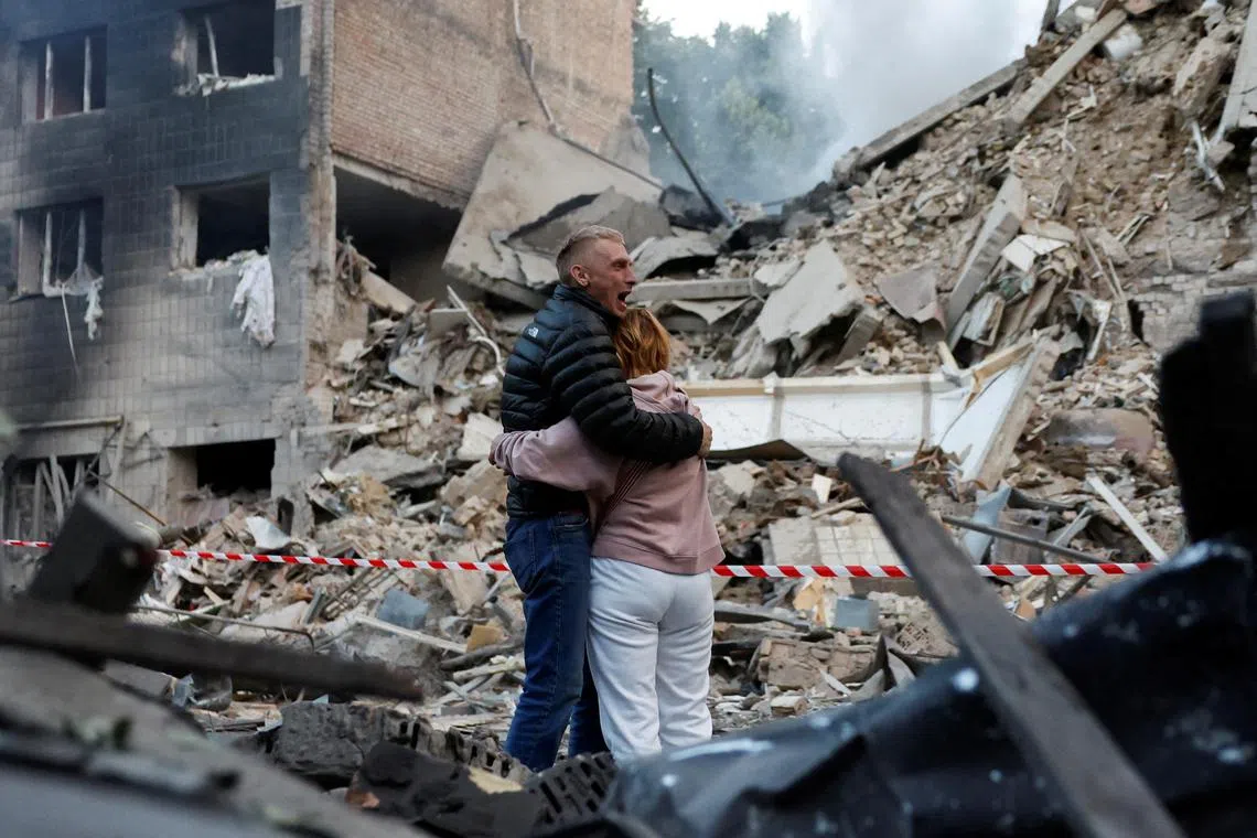 Residents react at the site of an apartment building damaged during a Russian strike in Kyiv, Ukraine on June 17, 2025. 