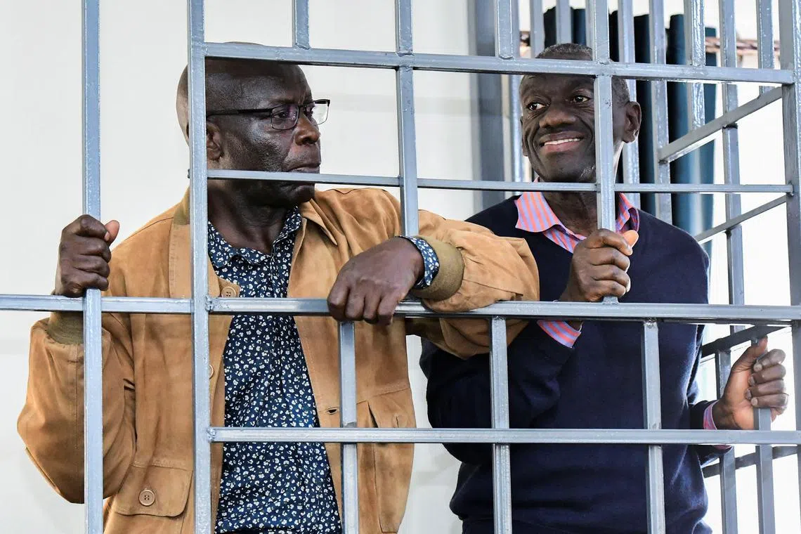 FILE PHOTO: Opposition leader Kizza Besigye and Obeid Lutale stand in a steel dock at the Uganda Military General Court Martial in Makindye, a suburb of Kampala, Uganda December 2, 2024. REUTERS Abubaker Lubowa/File Photo