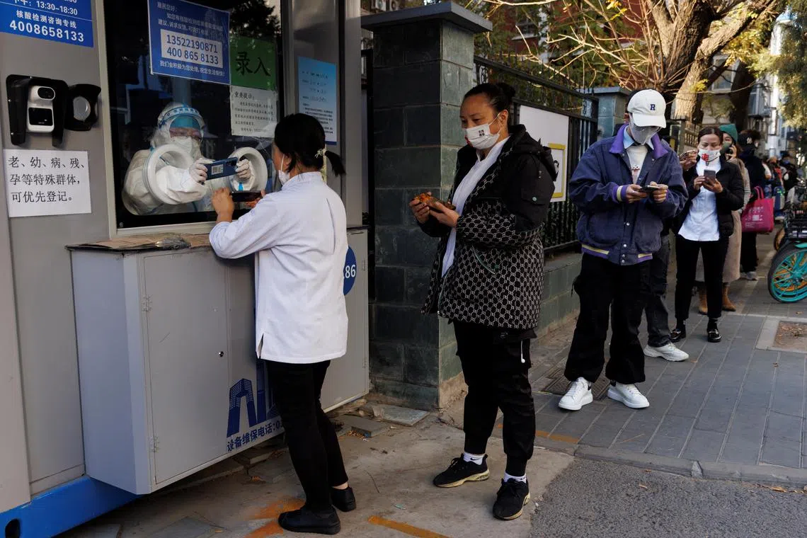 People line up to register their personal details before getting a swab test at a testing booth as outbreak of the coronavirus disease (Covid-19) continue in Beijing, China November 5, 2022. 