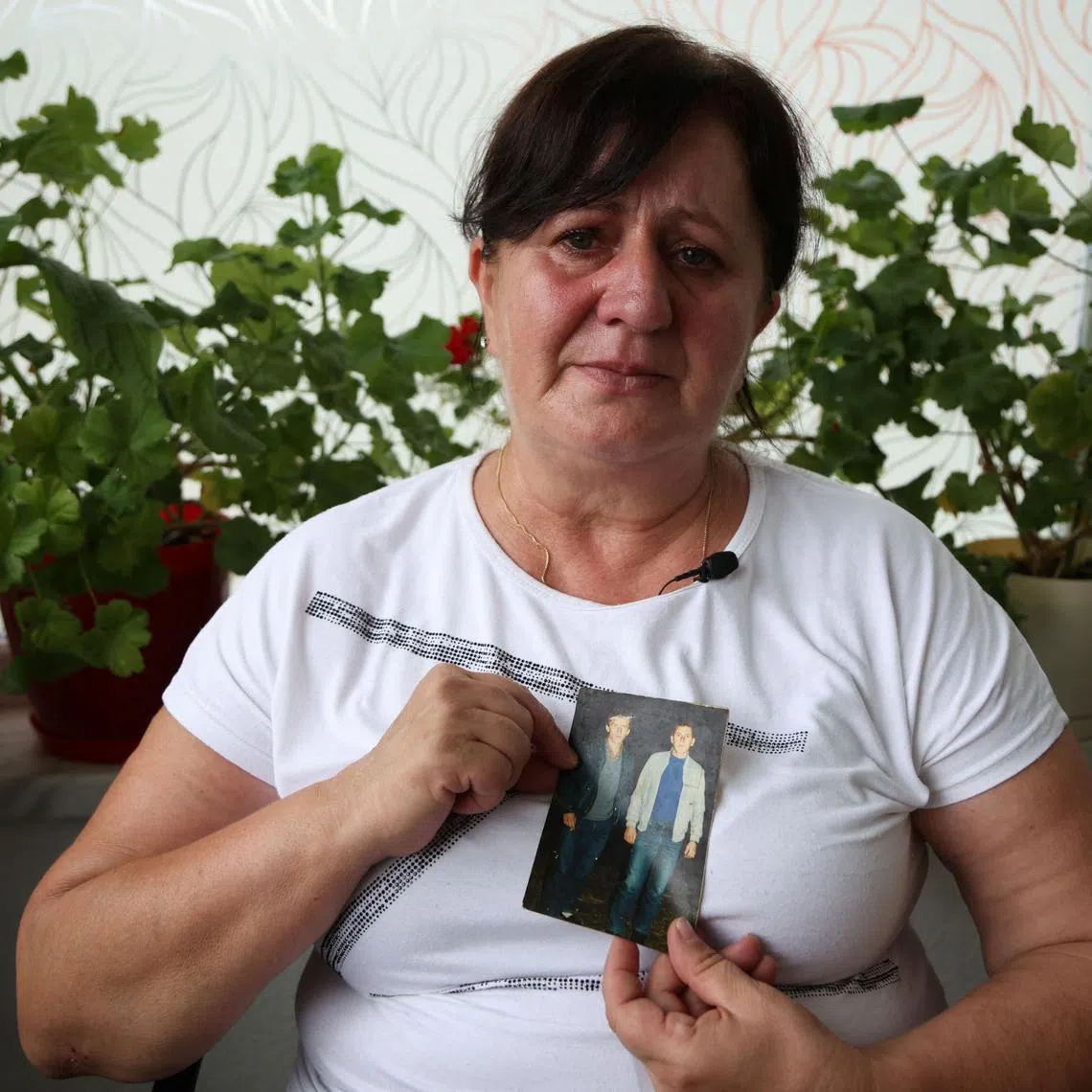 Mevlida Omerovic shows a photo of her husband Hasib (right), whose two bones she will bury on July 11, the 30th anniversary of the genocide in Srebrenica, and her relative Mensur, also killed in the genocide.