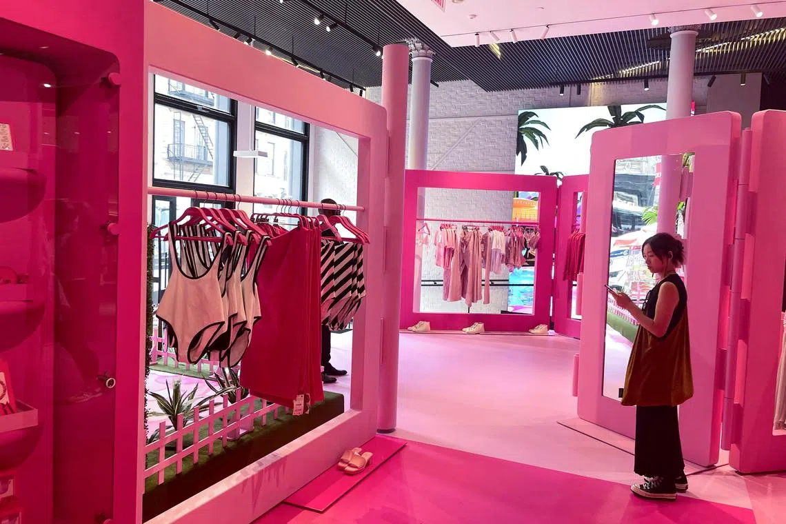 A shopper looks at her phone during the Barbie pop-up in Zara's Soho store in New York City, U.S. July 20, 2023. REUTERS/Arriana McLymore