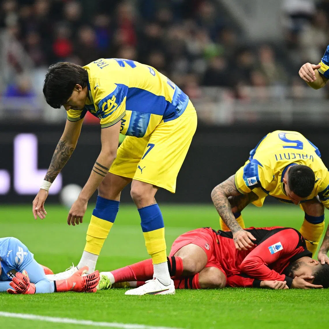 Soccer Football - Serie A - AC Milan v Parma - San Siro, Milan, Italy - February 22, 2026 AC Milan's Ruben Loftus-Cheek and Parma's Edoardo Corvi after both sustaining injuries from a collision REUTERS/Daniele Mascolo