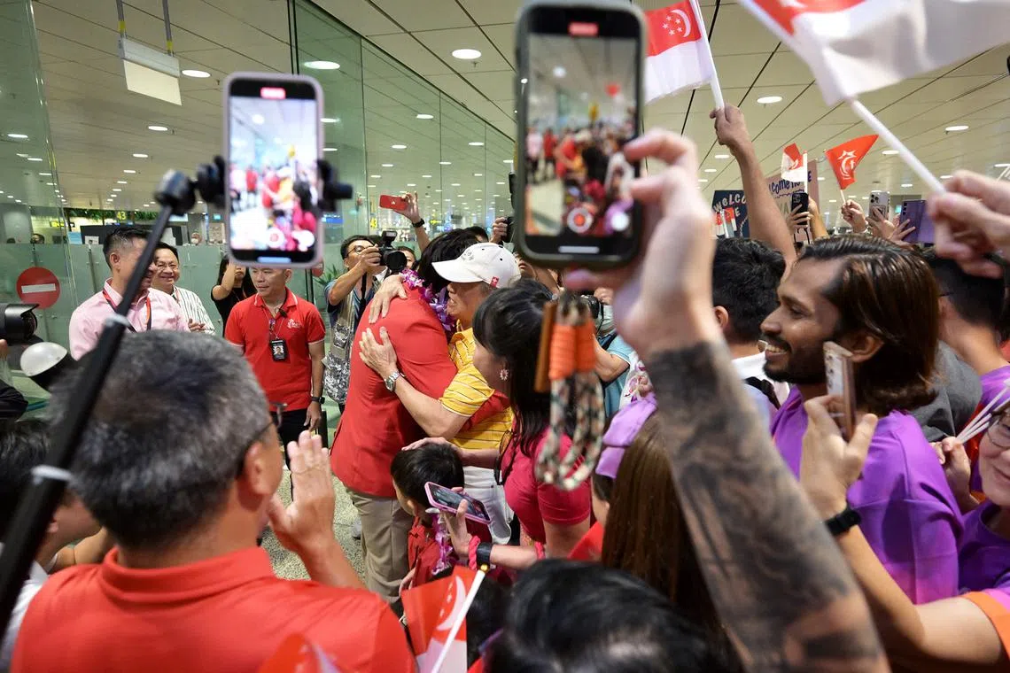 Singapore's Olympic bronze medallist Max Maeder gets a hug from his grandfather Teng Lay An, 83, upon his arrival at Changi Airport.