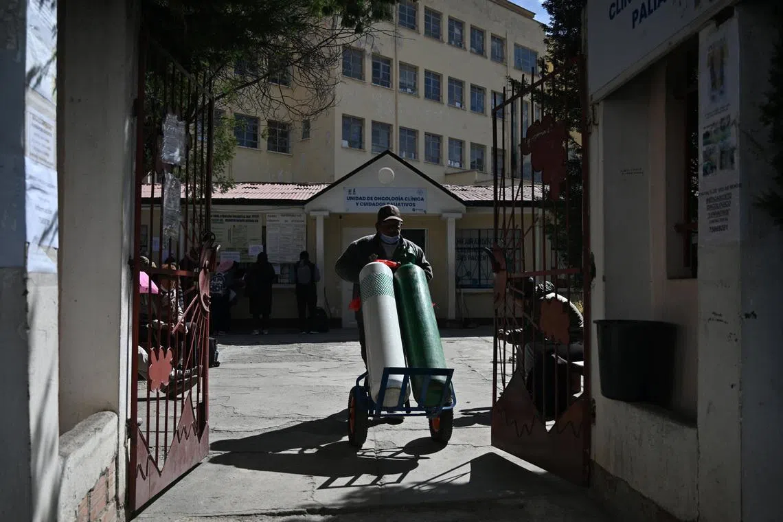 A worker at the General Hospital moves two oxygen tanks, amid prolonged road blockades that have disrupted the supply of food, fuel and medicine, causing a severe crisis in La Paz, Bolivia, June 18, 2026. REUTERS/Claudia Morales