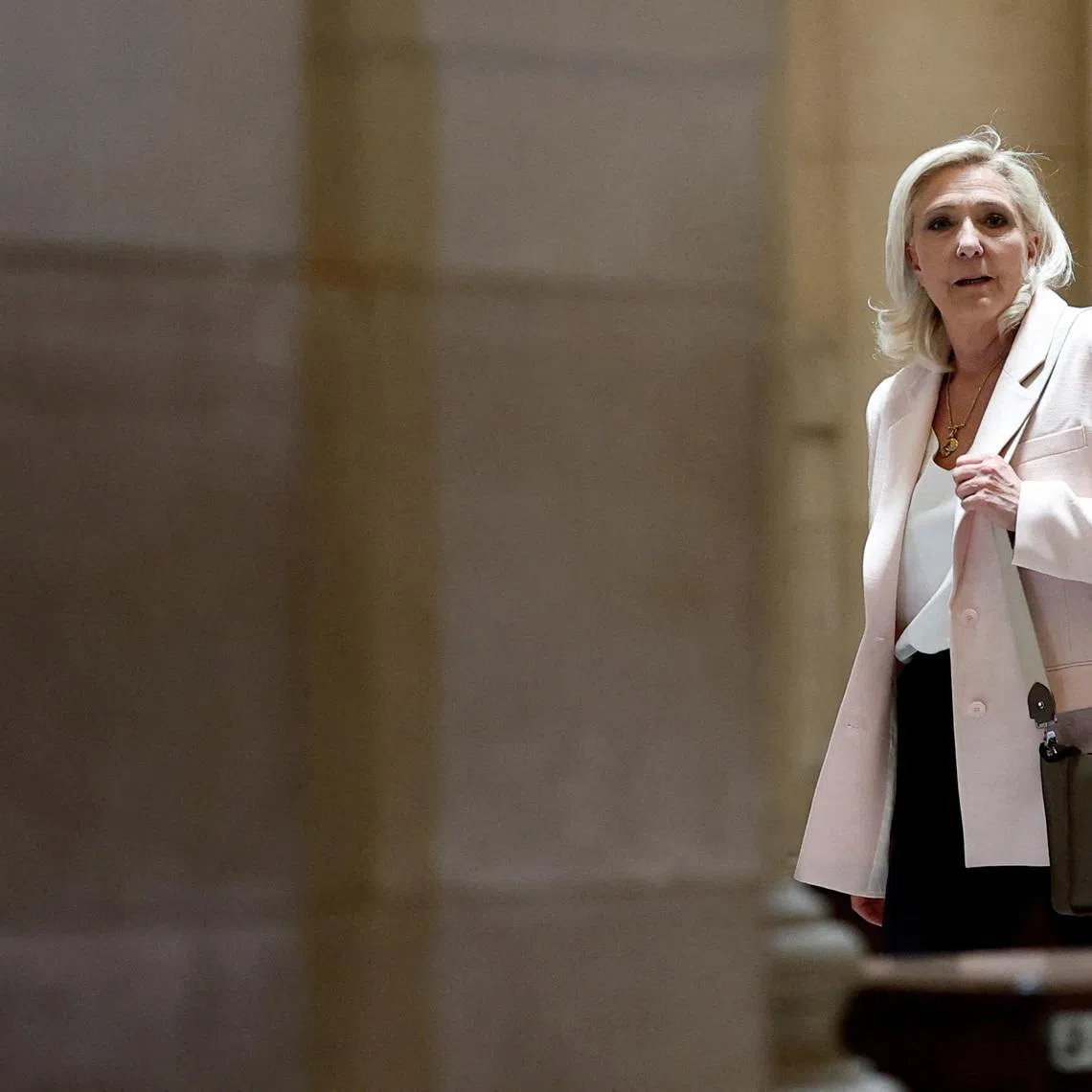 French far-right leader Marine Le Pen, member of parliament for the Rassemblement National (National Rally - RN) party, leaves after the verdict in her appeal trial, alongside the RN party itself and 10 others defendants found guilty of diverting European Parliament funds, at the Paris courthouse on the Ile de la Cite, in Paris, France, July 7, 2026. REUTERS/Benoit Tessier
