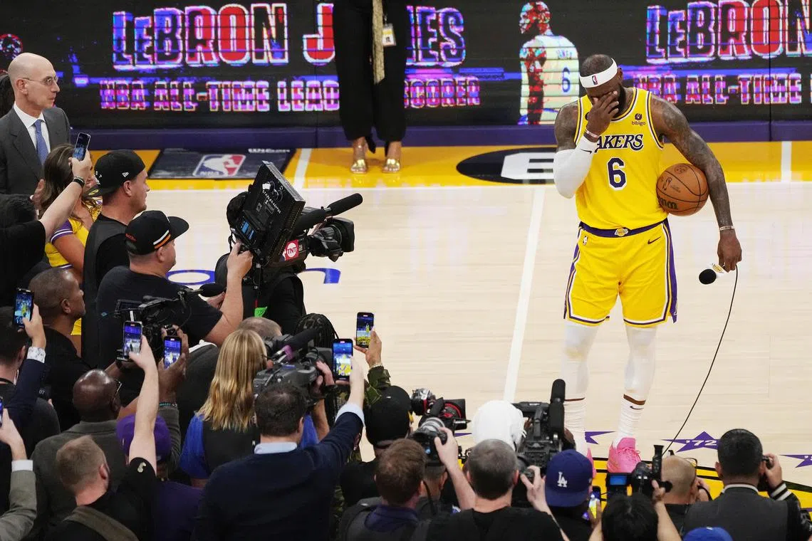 Los Angeles Lakers forward LeBron James (R) stands with his scoring basketball after becoming the all time highest scoring player in NBA history during the second half of the NBA basketball game between the Los Angeles Lakers and Oklahoma City Thunder at the Crypto.com Arena in Los Angeles, California, USA, Feb 7, 2023
