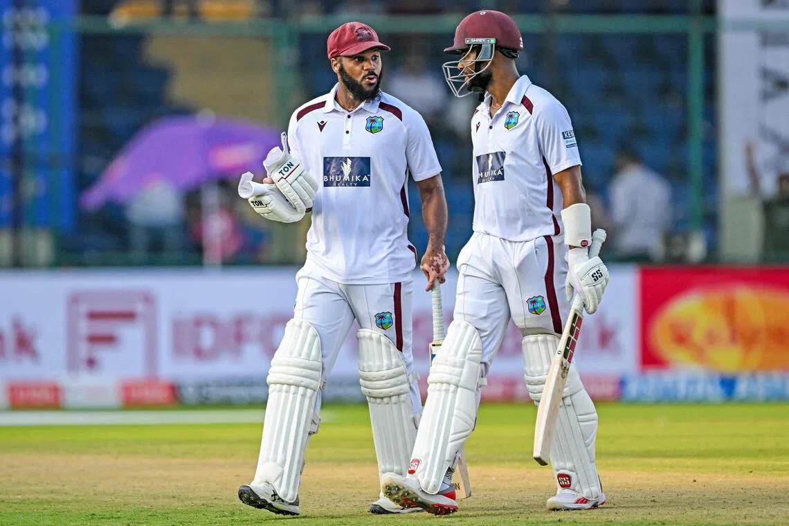 West Indies' John Campbell (left) and Shai Hope walk back to the pavilion at the end of play on the third day of the second and final Test cricket match against India at the Arun Jaitley Stadium in New Delhi on Oct 12, 2025.