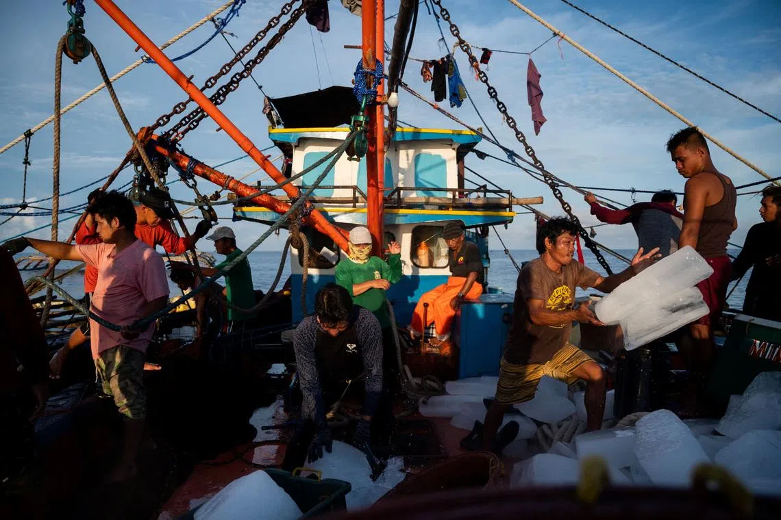 Filipino fishemen prepare ice during a trip near the disputed Scarborough Shoal, in Masinloc, Zambales province, Philippines, on July 18, 2022.
