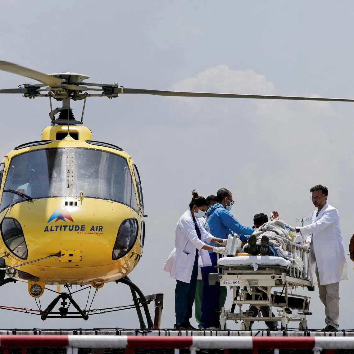 Paramedics work to transport Dawa Sherpa, who was missing for several days in the Everest region, from the helipad at HAMS Hospital in Kathmandu, Nepal, June 4, 2026. REUTERS/Navesh Chitrakar