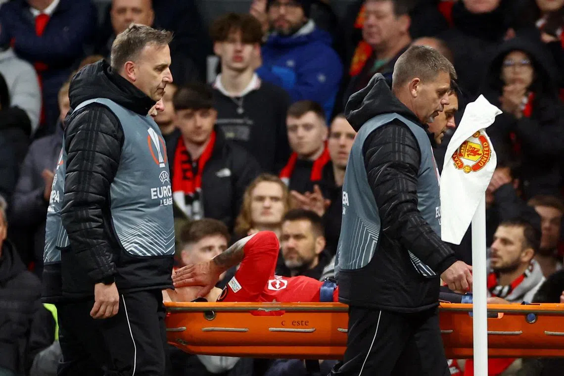 Manchester United's Lisandro Martinez is carried away on a stretcher after picking up an injury against Sevilla. He has been ruled out for the rest of the season.