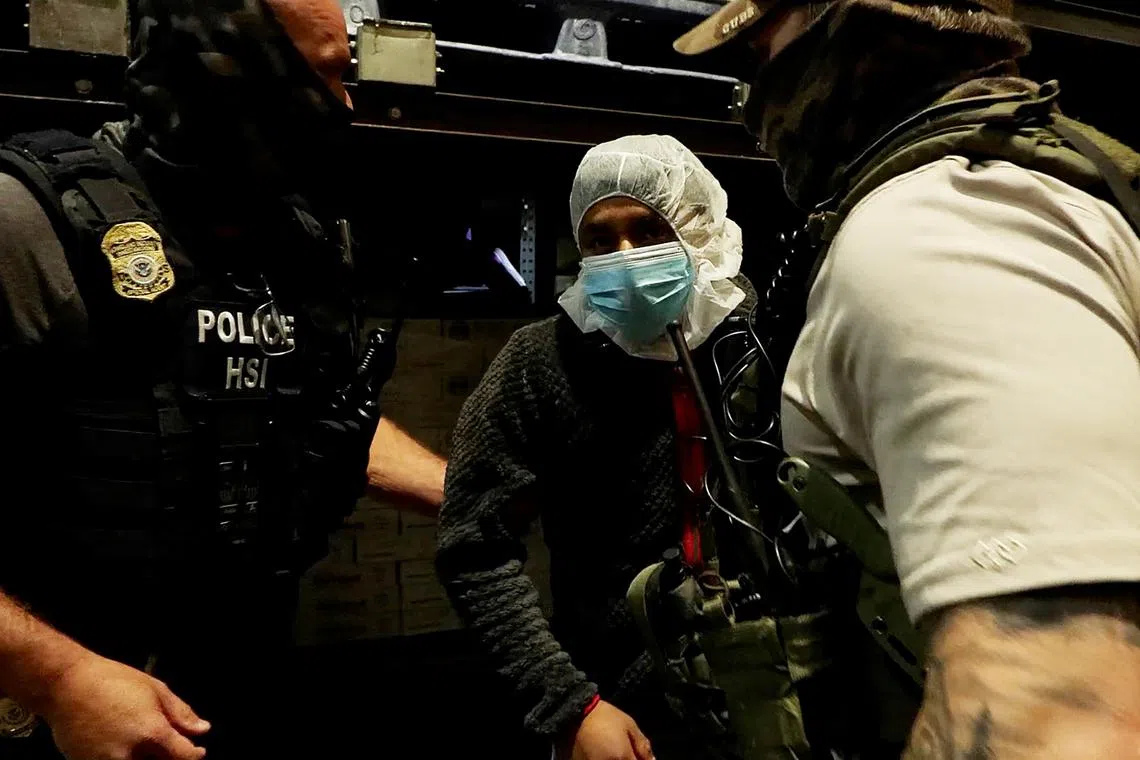 A man is detained during a raid by U.S. Immigration and Customs Enforcement (ICE) at a Glenn Valley Foods meat production plant in Omaha, Nebraska, U.S. June 10, 2025 in a still image from video.  U.S. Immigration and Customs Enforcement/Handout via REUTERS