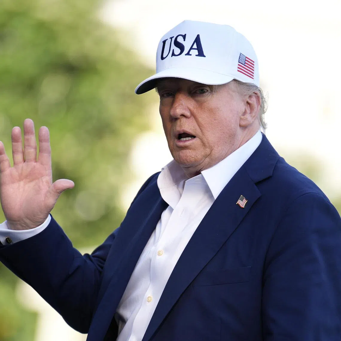 US President Donald Trump waves to reporters on the South Lawn of the White House on July 6.