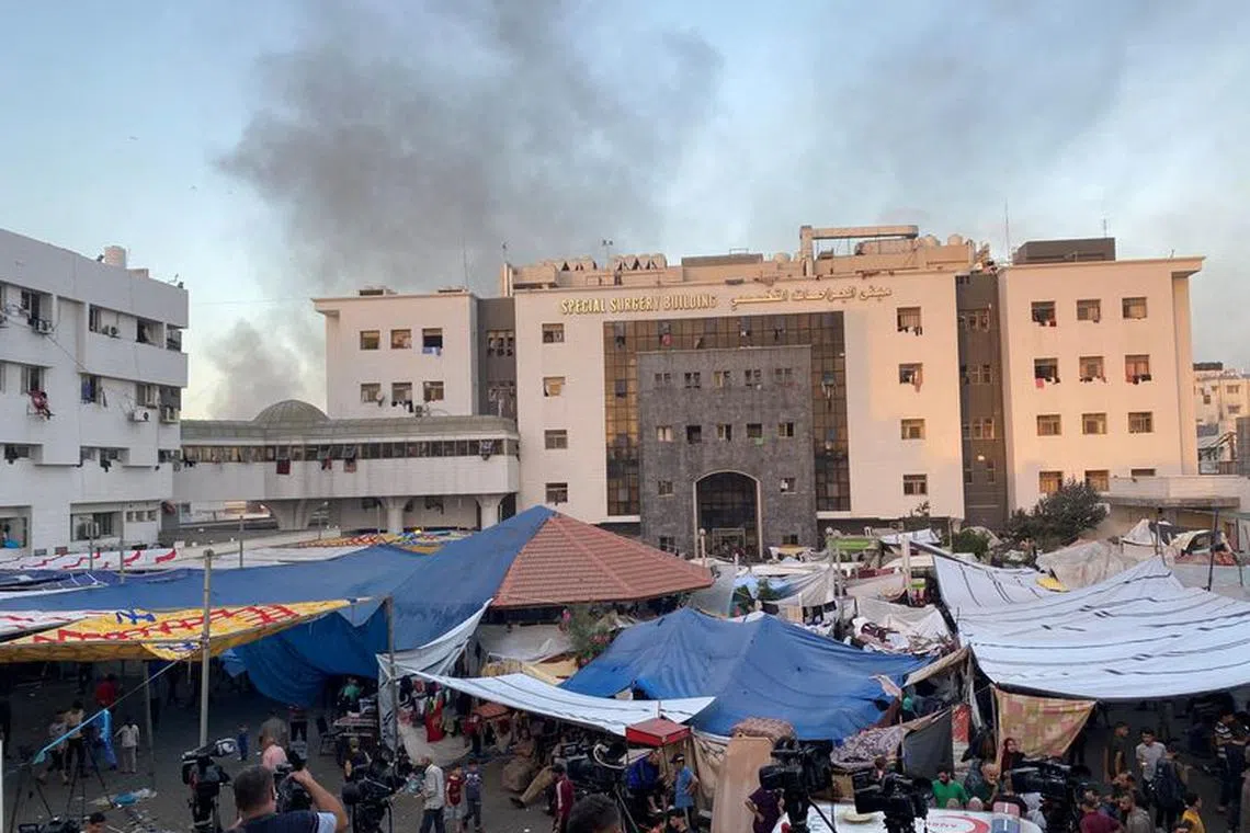 FILE PHOTO: Smoke rises as displaced Palestinians take shelter at Al Shifa hospital, amid the ongoing conflict between Hamas and Israel, in Gaza City, November 8, 2023. REUTERS/Doaa Rouqa/File Photo