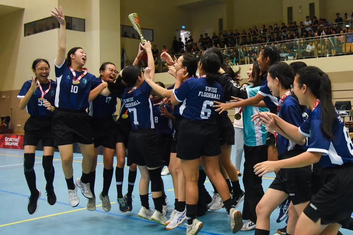 The Swiss Cottage Secondary School girls floorball team celebrating their B Division title at Our Tampines Hub Sports Hall on April 29, 2024. 