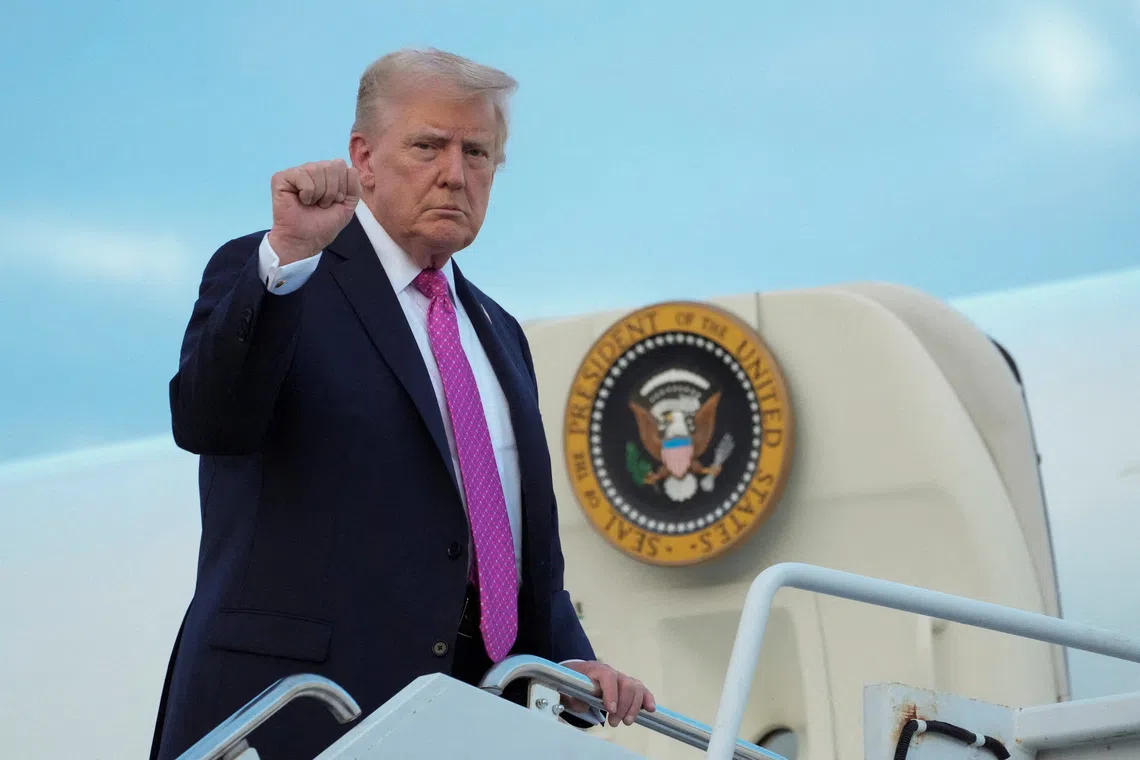 FILE PHOTO: U.S. President Donald Trump gestures as he boards Air Force One to depart for Washington, at Morristown Municipal Airport in Morristown, New Jersey, U.S., September 14, 2025. REUTERS/Ken Cedeno/File Photo