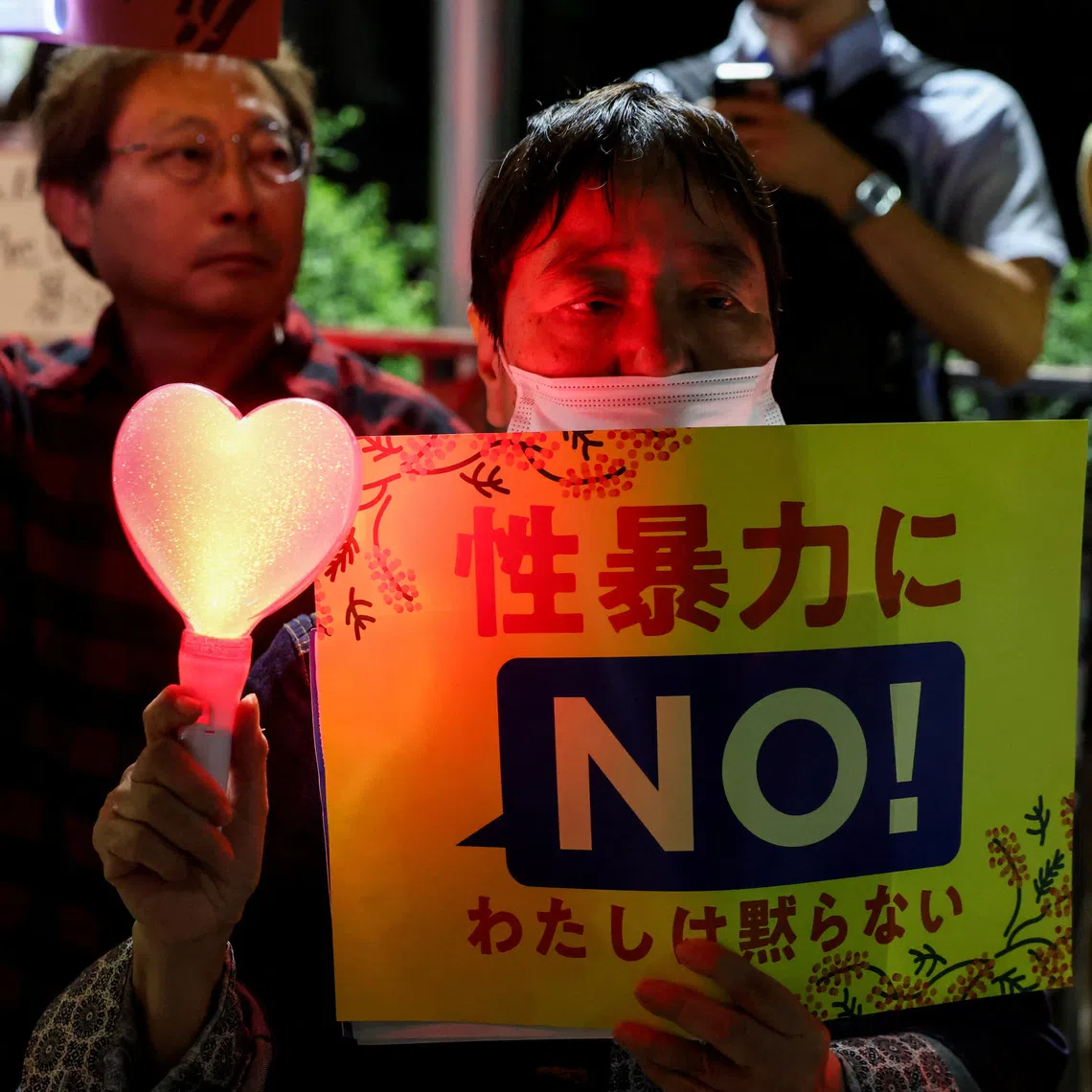 A demonstrator holds a “no to sexual violence” placard in protest following the killing of a Japanese woman in Okinawa.