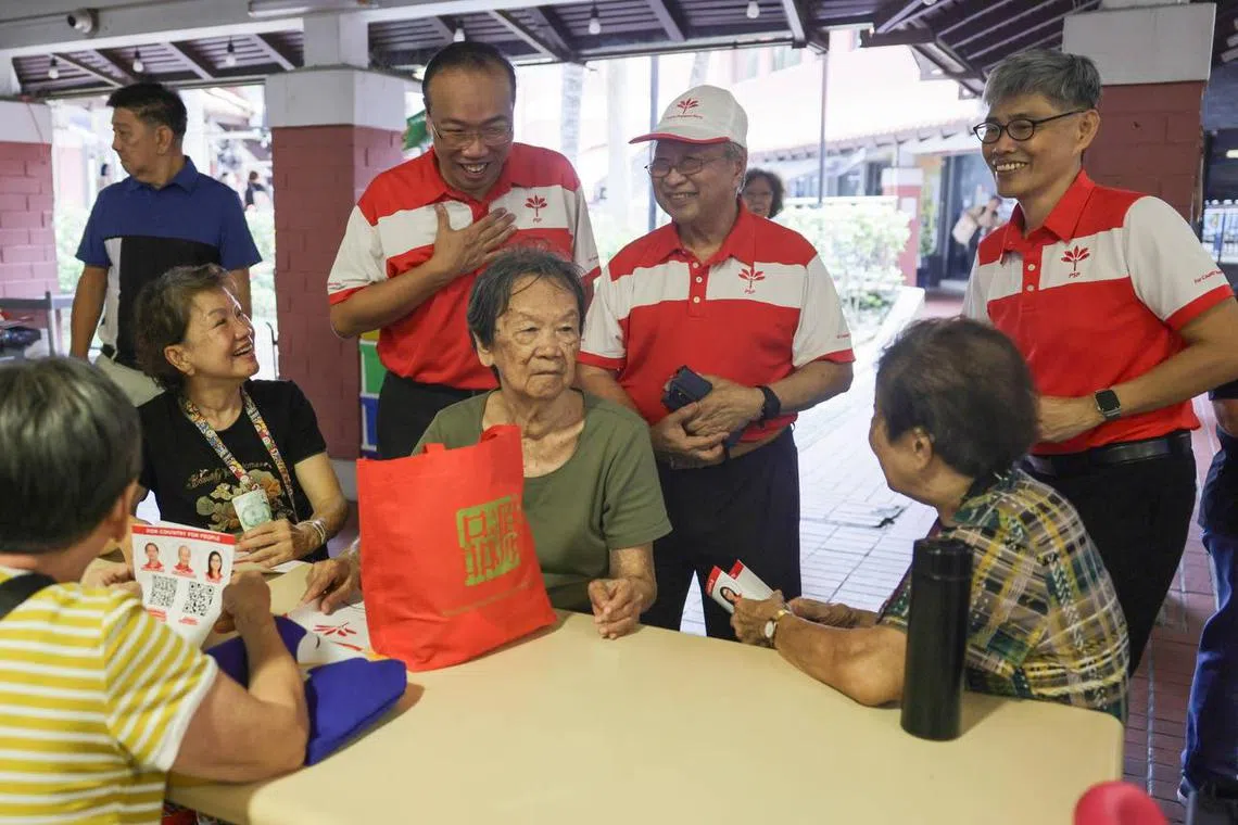 PSP chairman Tan Cheng Bock (centre) with Mr Jeffrey Khoo (left) and Mr Tony Tan during a walkabout at Bishan Street 22 on April 17.