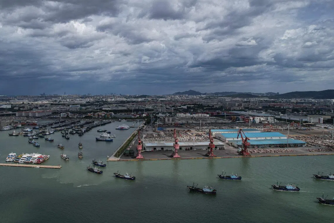 Fishing boats are seen returning to port to avoid Typhoon Gaemi in Xiamen, in eastern China's Fujian province, on July 24, 2024.
