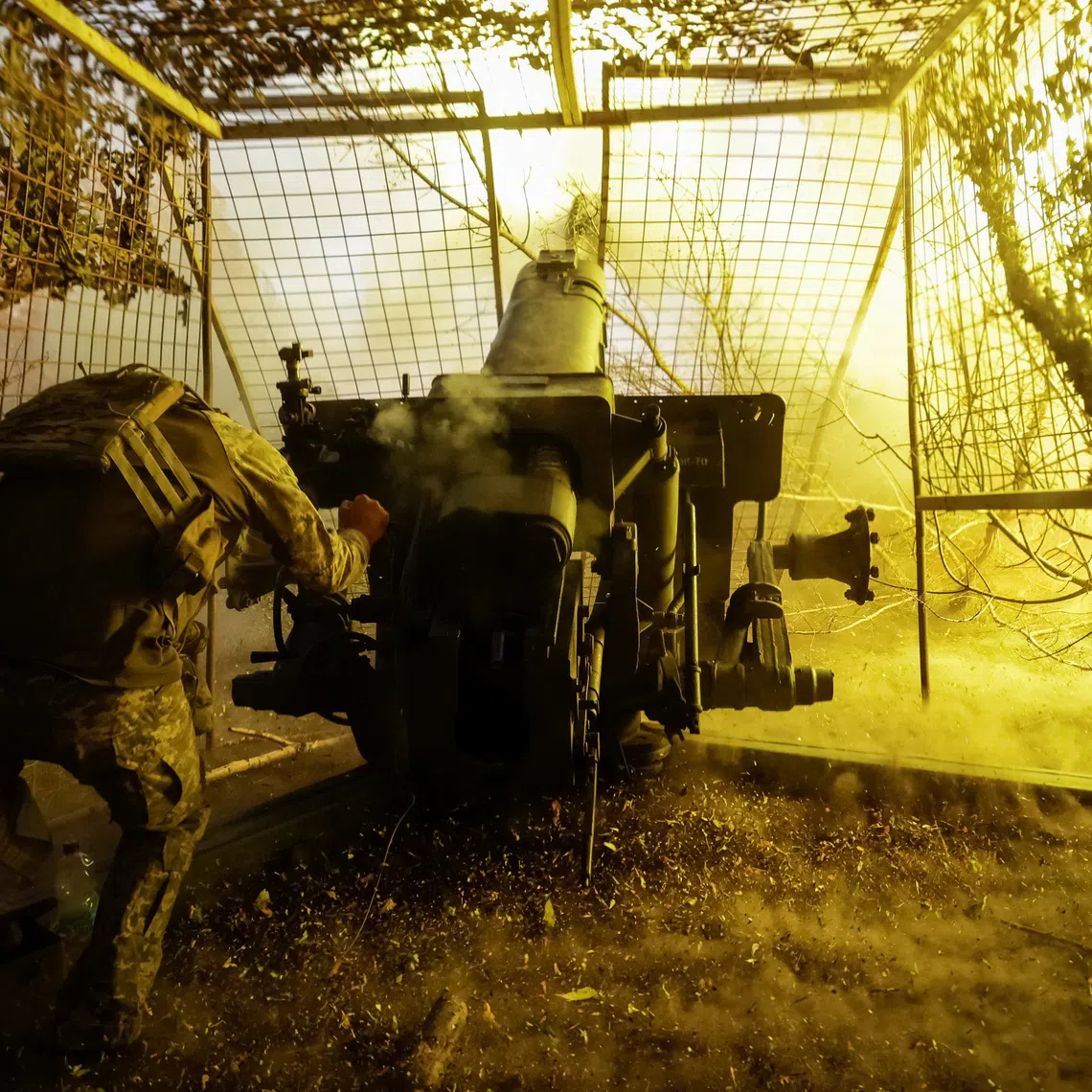 A Ukrainian soldier fires a D-30 howitzer towards Russian troops near the front line town of Kupiansk in Kharkiv region, Ukraine.