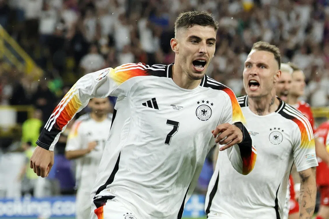Germany's Kai Havertz (left) celebrates after converting a penalty to score his team's first goal.
