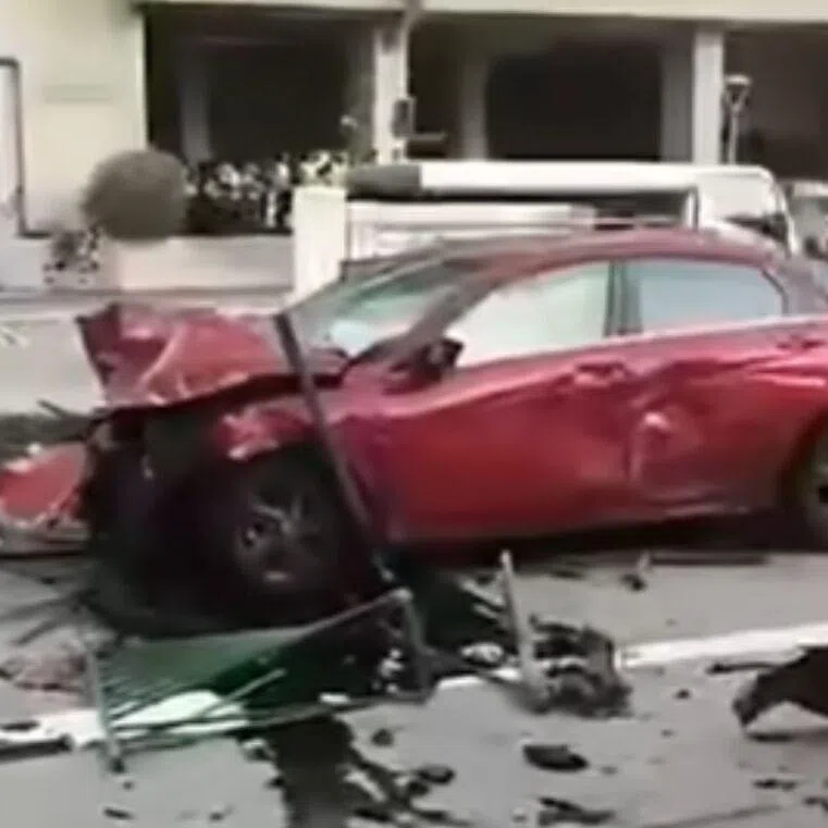 Debris, including a section of a road divider fence, is strewn across three lanes of the road in Kallang Bahru.