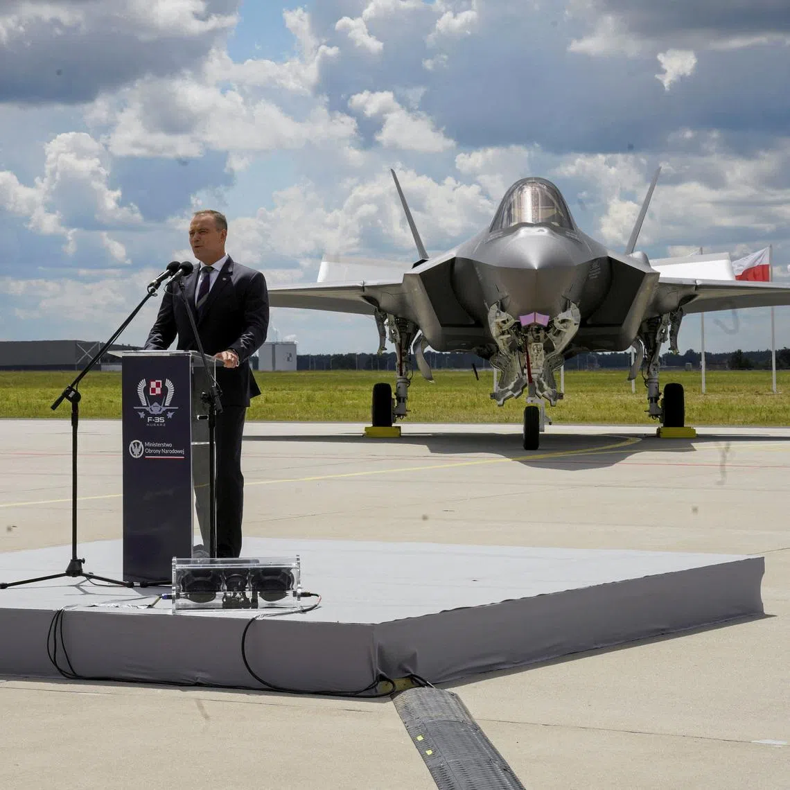 Poland's President Karol Nawrocki speaks in front of a newly acquired Polish F-35 Lightning II stealth strike fighter, named 'Husarz' in reference to the Polish \"winged hussar\" cavalry units, on the day of a ceremony marking their official induction into the Polish Armed Forces at the 32nd Tactical Air Base in Lask, Poland, June 12, 2026.  Agencja Wyborcza.pl/Marcin Stepien/via REUTERS