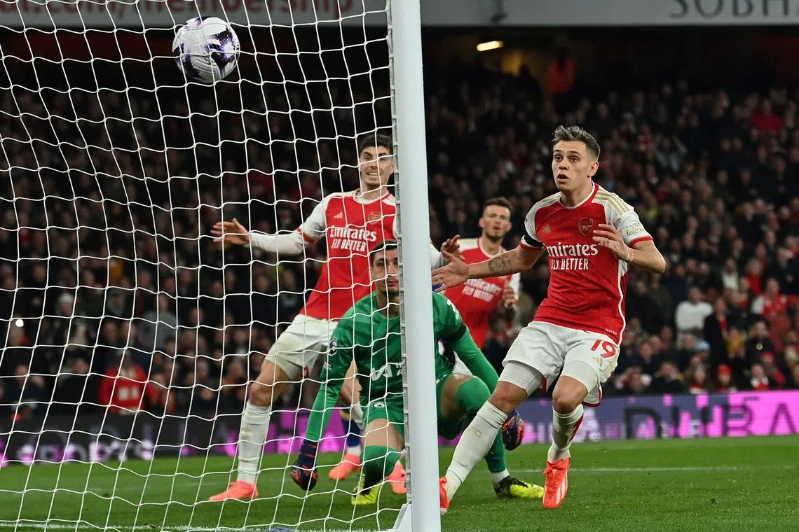Arsenal defender Ben White (second from left) looks on as his cross-shot hits the back of the Chelsea net for their fifth goal.
